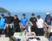 anglers stood in a line at the back of a fishing boat