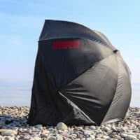 beach fishing brolly shelter on pebble beach