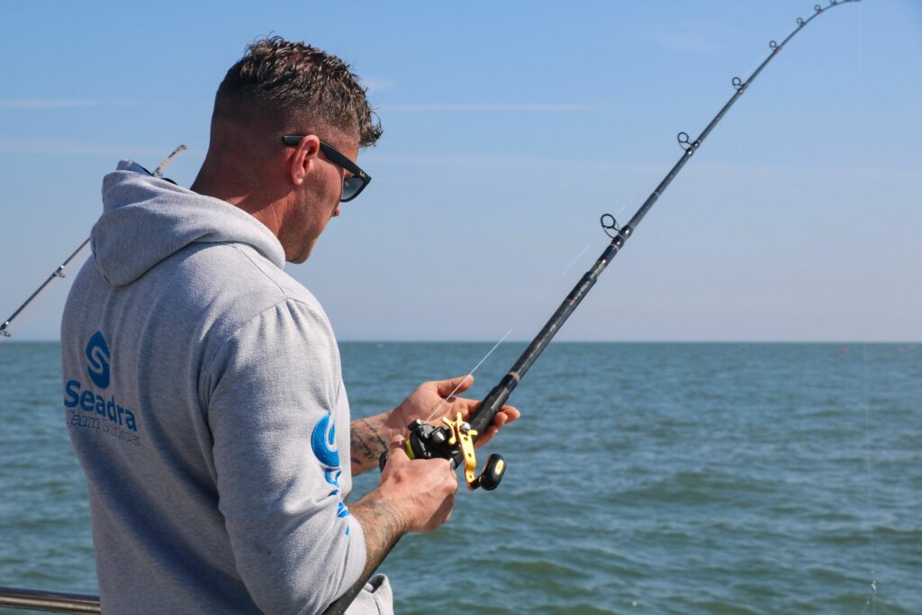 man holding a fishing rod on a boat