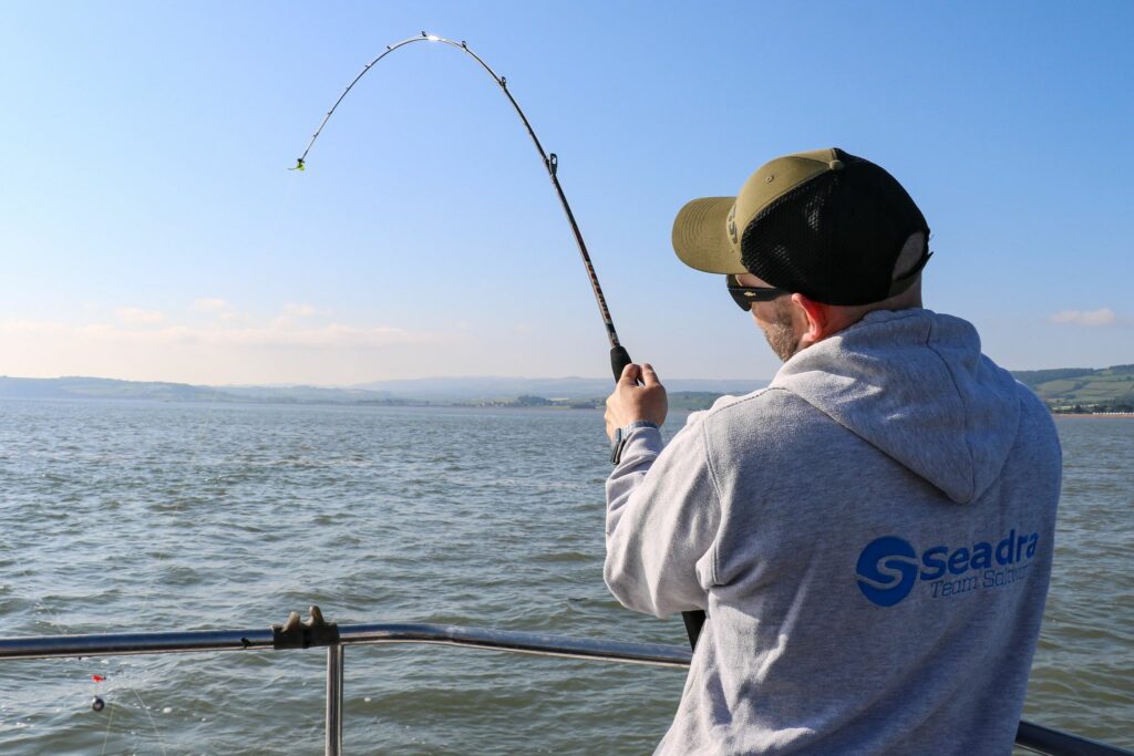 man holding bent fishing rod