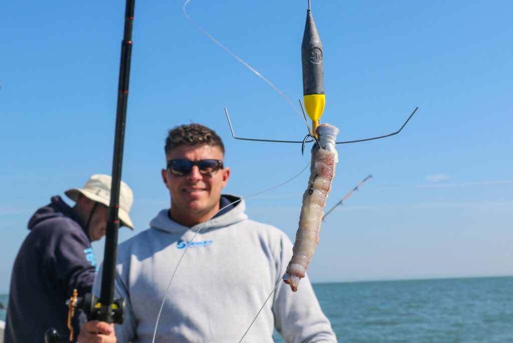 man with baited hook and fishing rod on a boat
